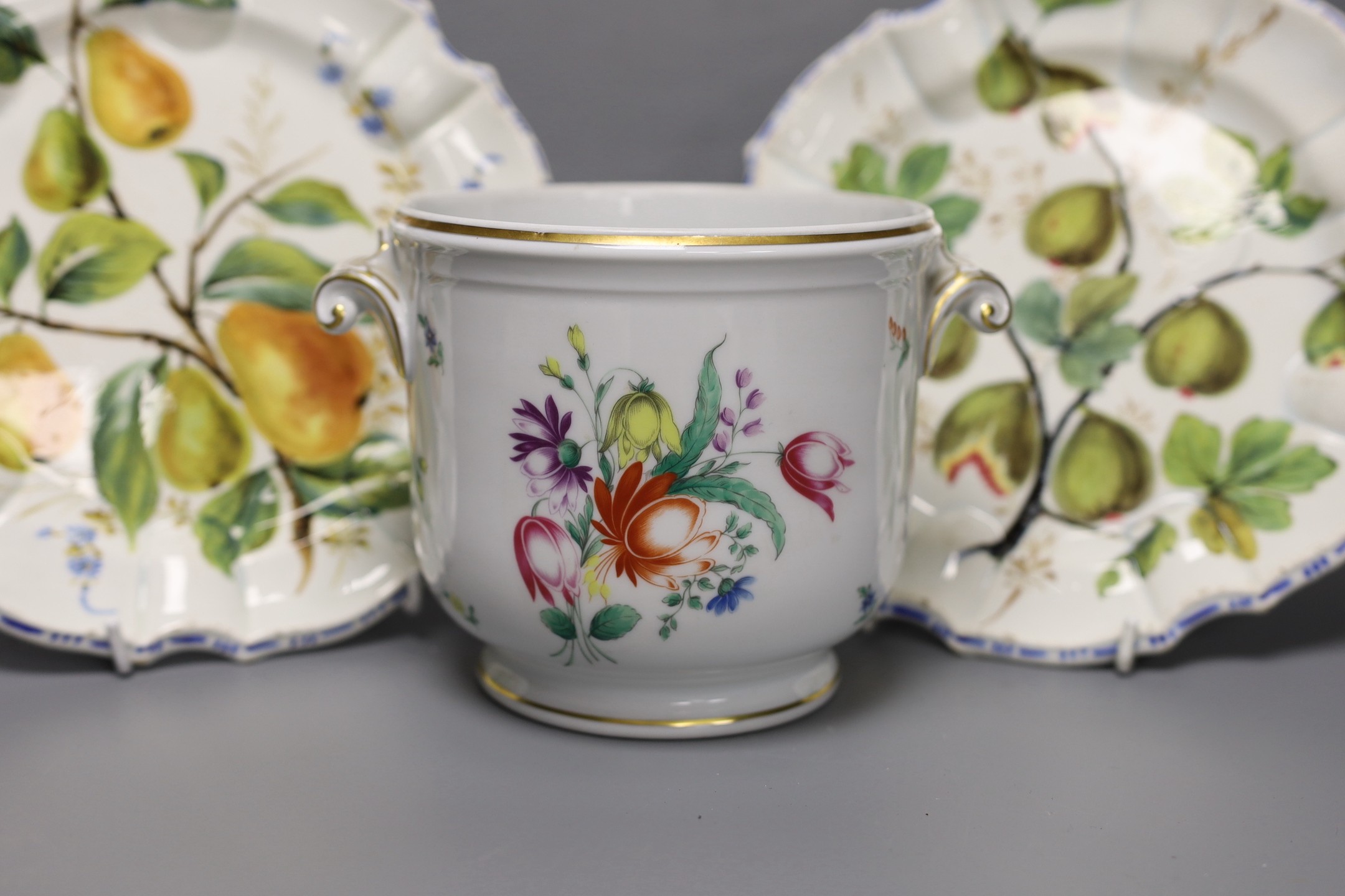 A pair of Meissen onion pattern candlesticks, 14 cm high, a Berlin figural salt, two Nove maiolica plates and a Richard Gingrich cache pot